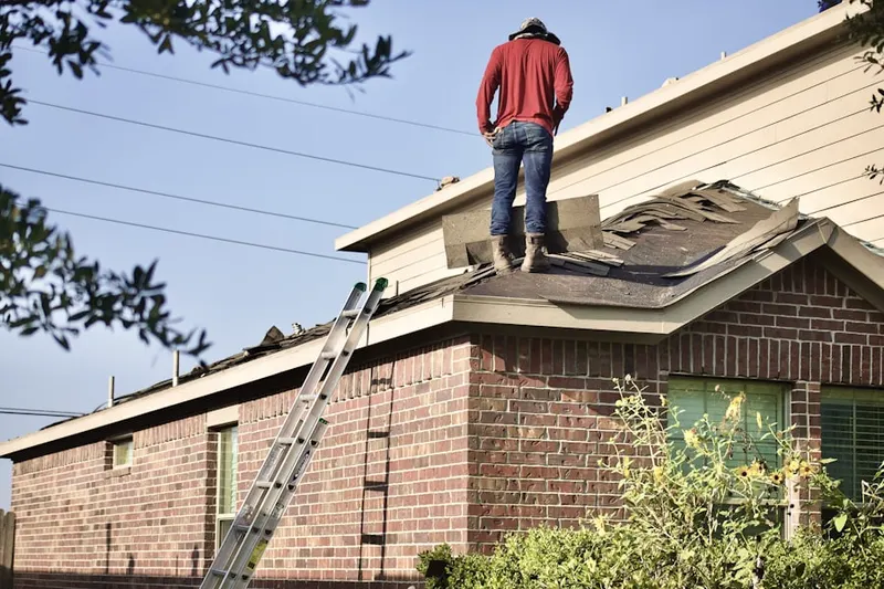 Professional roofer working on a residential roof in Owings